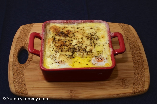 Shirred eggs cooked on a base of Spam and cooked with parmesan cheese and cream. 